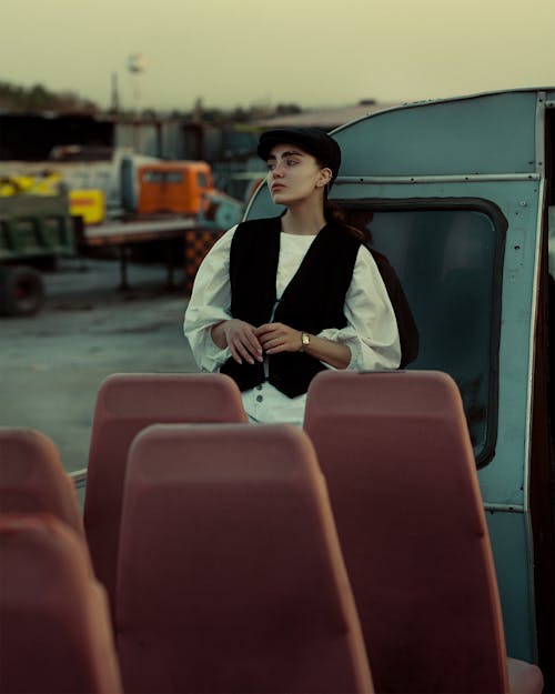 Guide in a Black Flat Hat and Waistcoat by the Seats of an Open Tourist Bus