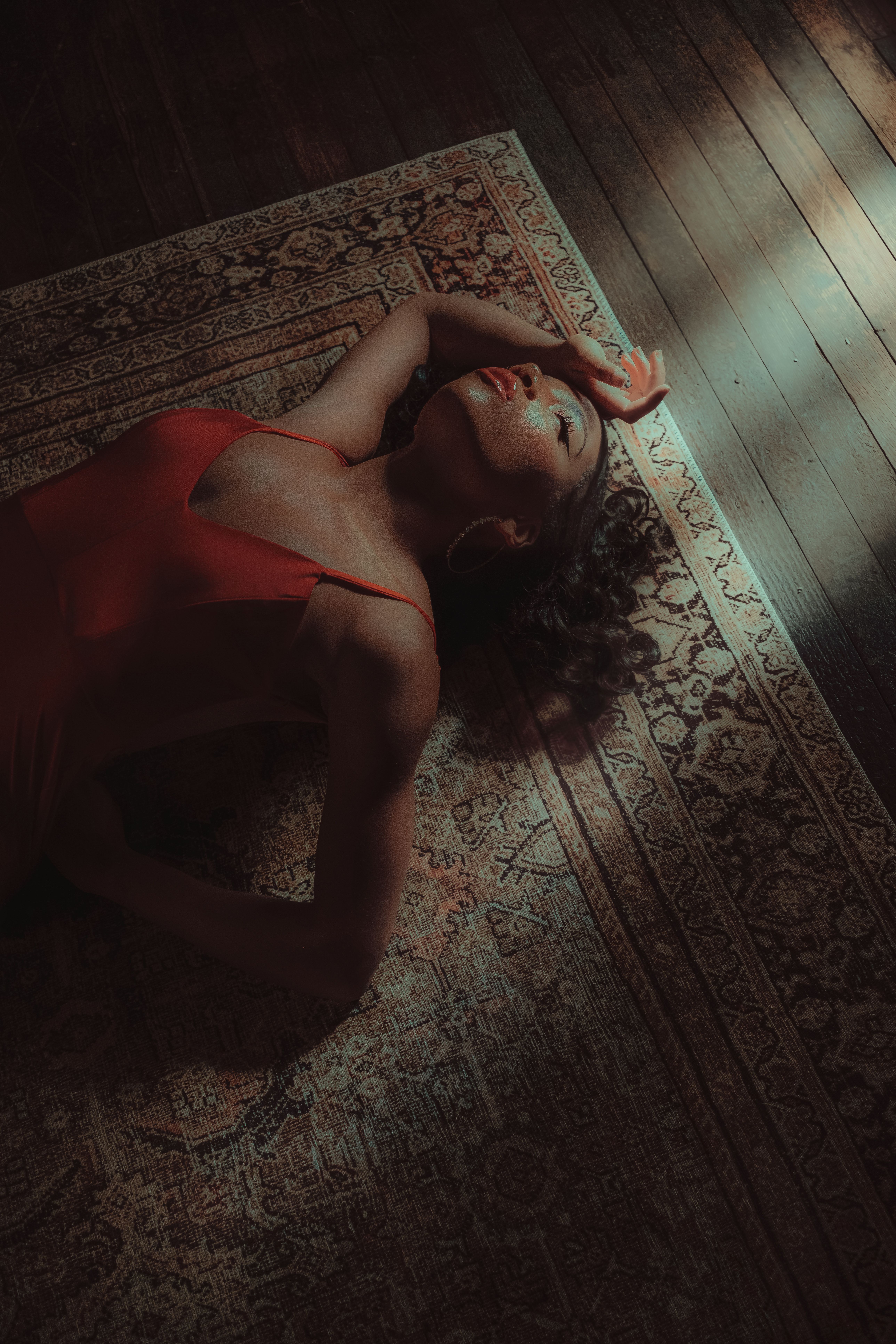 Woman in Red Dress Lying Down on Carpet  Free Stock Photo