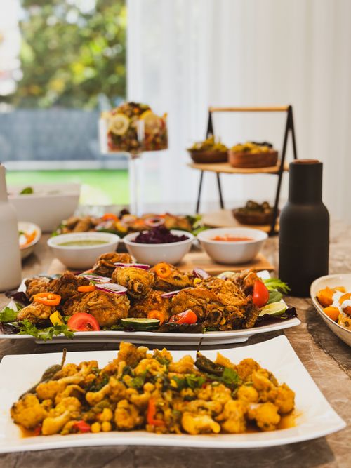Free An elegant table setting featuring a variety of colorful homemade dishes, perfect for a vibrant dining experience. Stock Photo