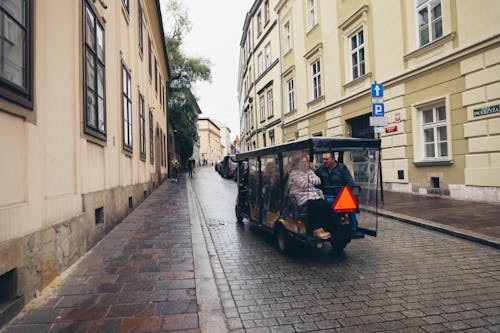 People in Golf Cart on Street in Old Town in Krakow