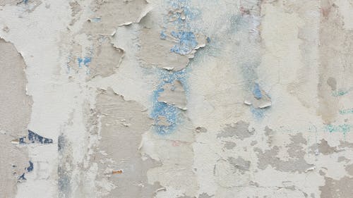 A close up of a wall with peeling paint