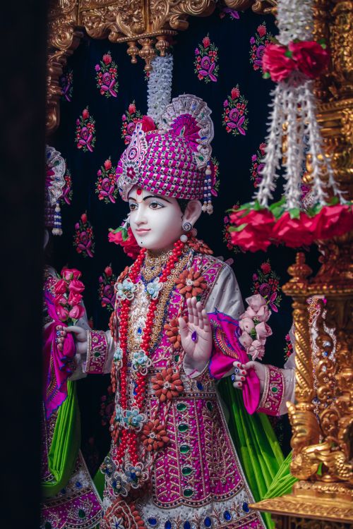 Free Close-up of a richly decorated Hindu deity statue adorned with jewelry in a temple setting. Stock Photo