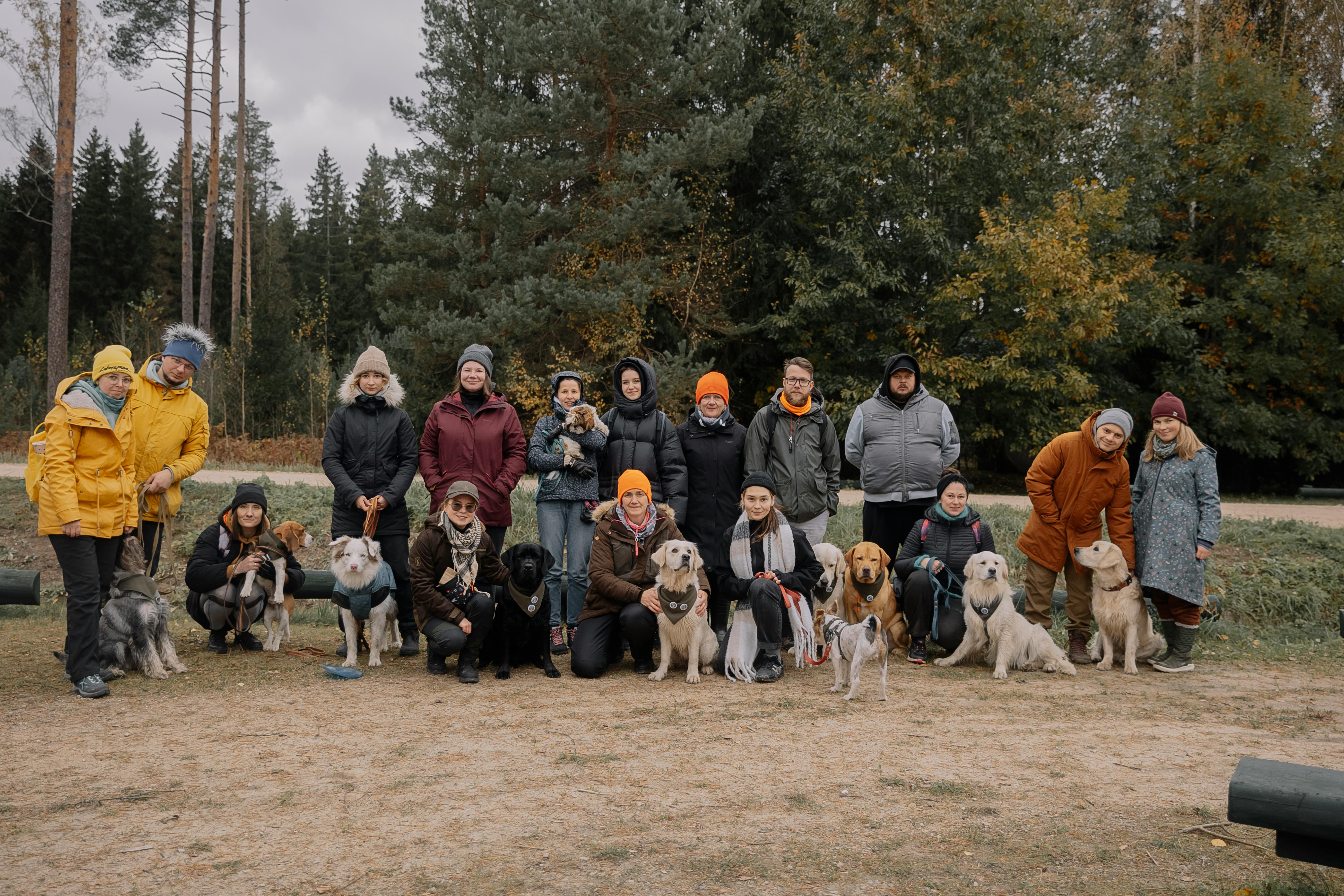 Group of Hikers Posing Together with Various Dogs