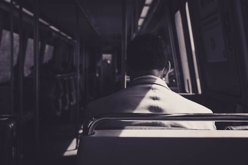 Man Sitting on Public Transportation