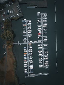 Drone shot of a marina with moored boats in Seattle, WA, showcasing a tranquil lakeshore scene.