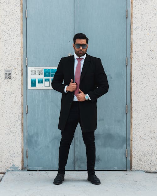 Portrait of a Male Model Wearing an Elegant Suit and Sunglasses