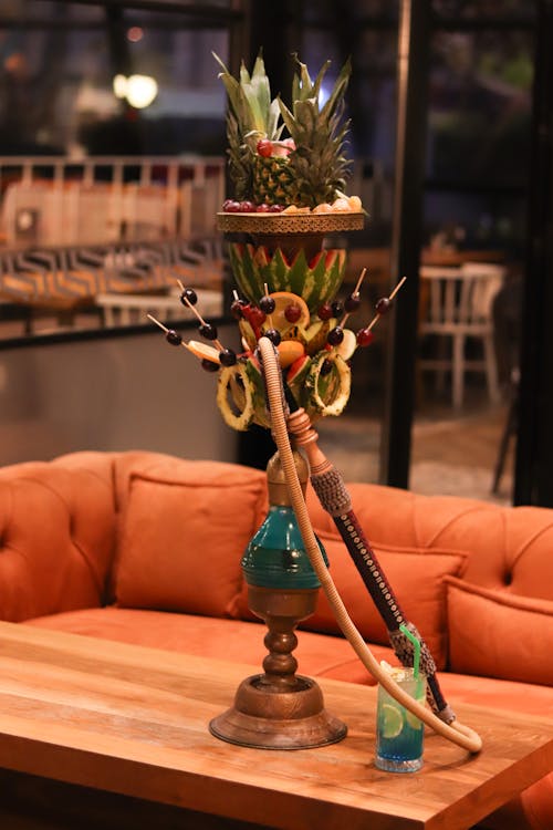 Hookah Decorated with Pineapples and Fruits Standing on a Wooden Table