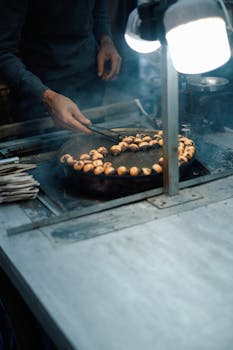 A street vendor roasting chestnuts over an open flame, capturing an autumn evening scene.