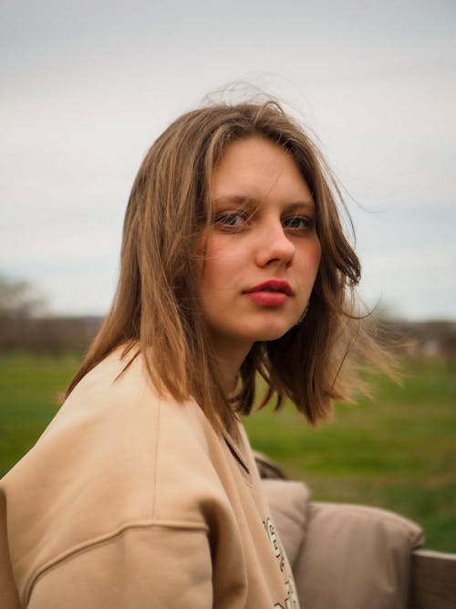 Blonde Woman Looking Straight into Camera Lens