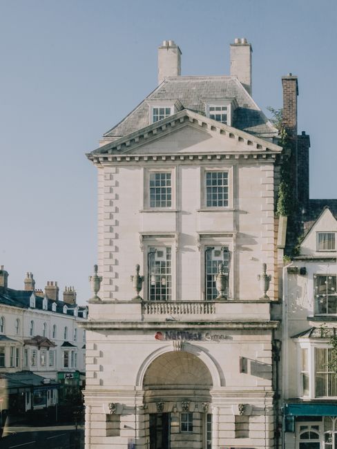 Elegant Georgian architecture of the NatWest bank in Llandudno, captured in soft daylight.