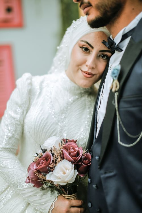 Free A joyful bride and groom captured in an intimate wedding portrait. Stock Photo