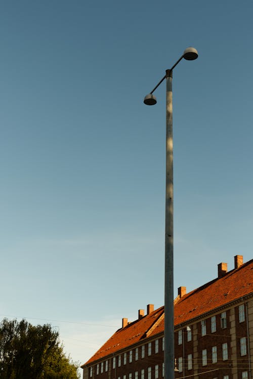 Old Street Lights on a Lamp Post near Red Brick Building