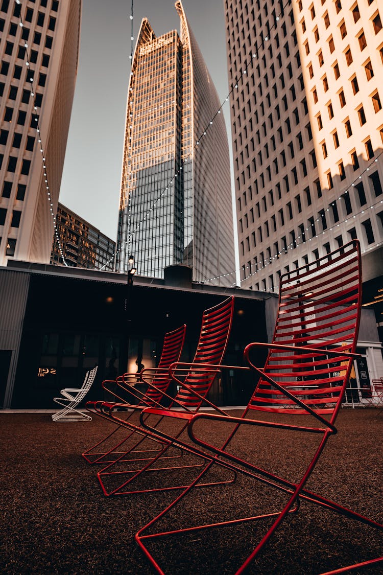 Elegant Red Metal Chairs Standing At A Plaza Near Skyscrapers In Atlanta, Georgia, USA