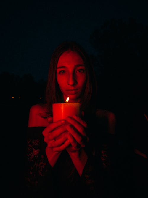 Woman at Night Holding Candle