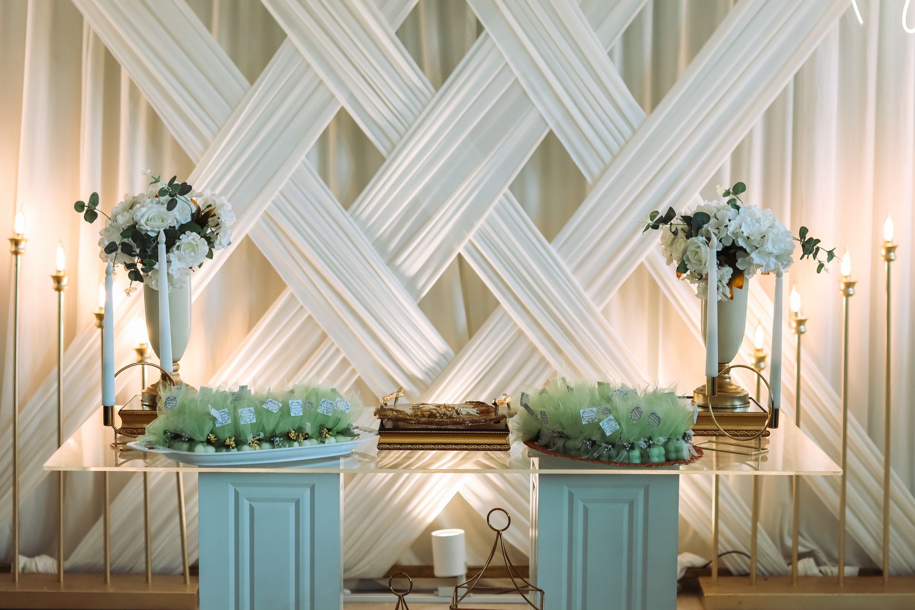 Sophisticated wedding table setting with floral arrangements and ambient lighting.