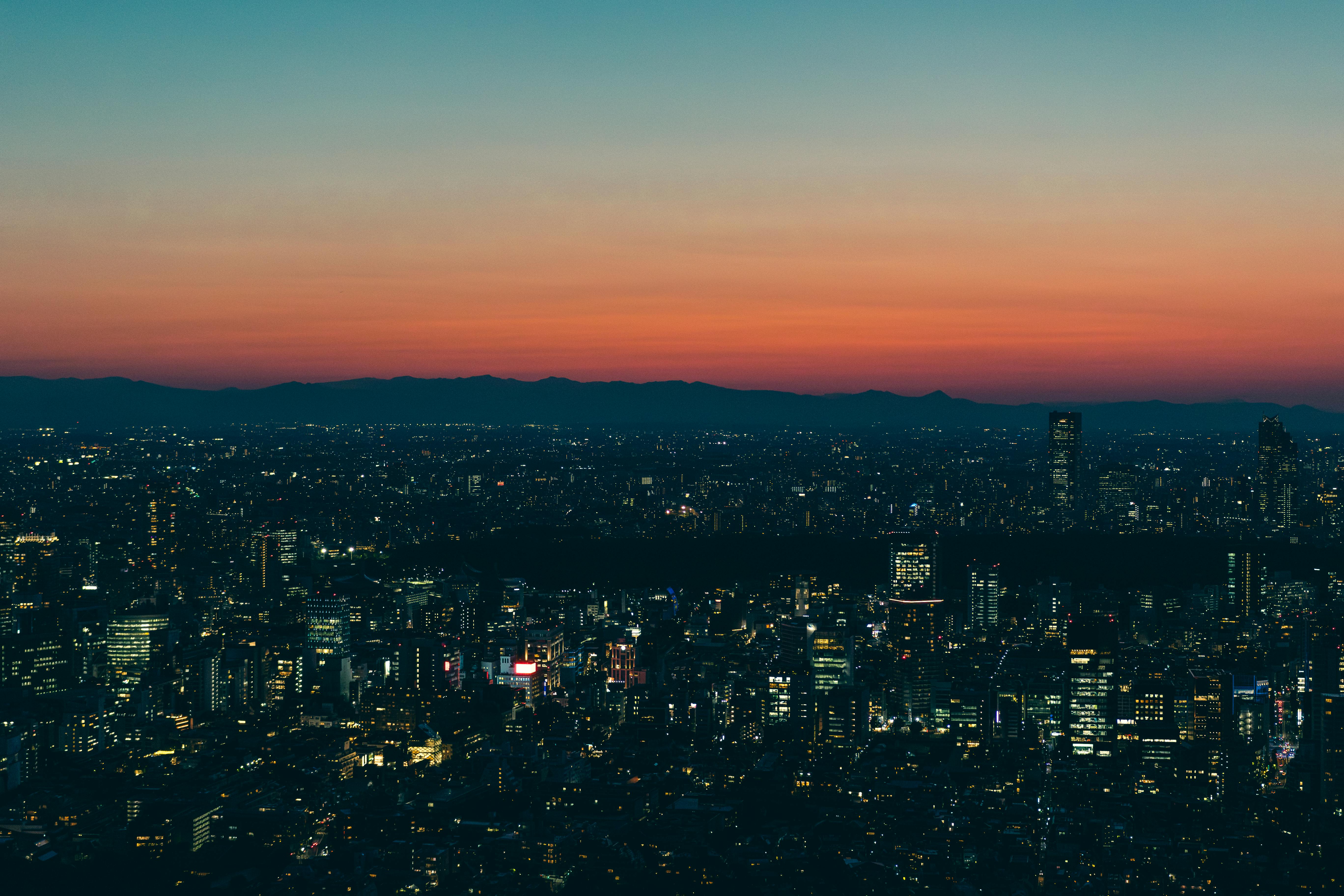 Vibrant Tokyo cityscape at twilight, with skyscrapers and an evening skyline against colorful skies.