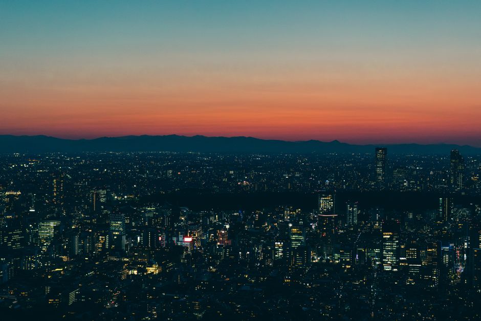 Vibrant Tokyo cityscape at twilight, with skyscrapers and an evening skyline against colorful skies.