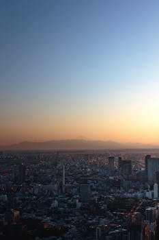 Breathtaking view of Tokyo's skyline at dawn with Mount Fuji in the background.