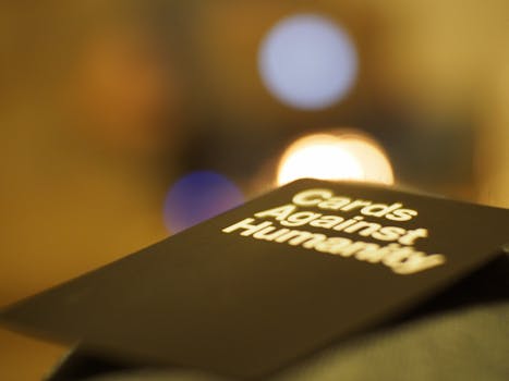 Artistic shot of Cards Against Humanity with a bokeh background.