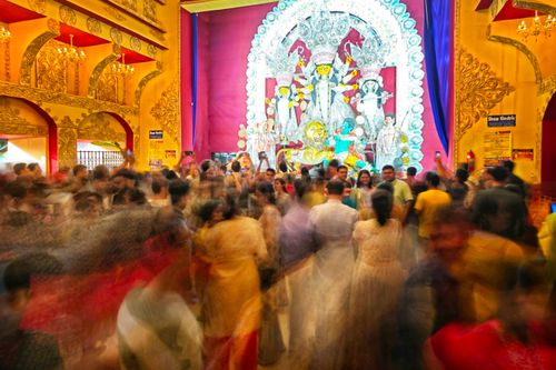 Free Blurred motion scene of devotees attending Durga Puja in Kolkata temple, India. Stock Photo