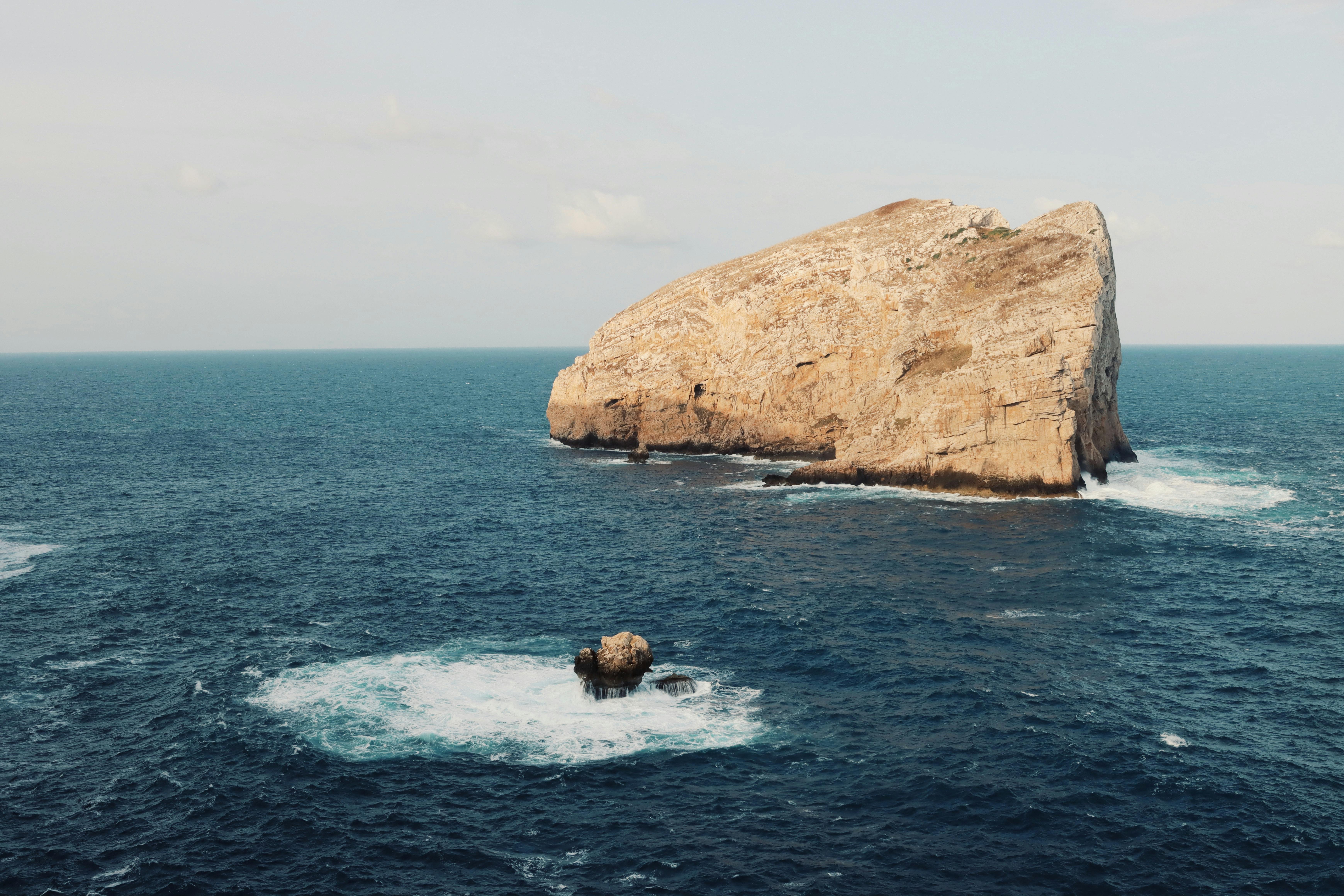 A stunning vista of rocky island formations off the coast of Alghero, Sardinia, Italy.