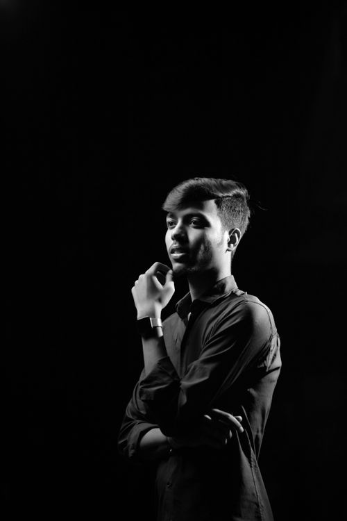 Free Black and white portrait of a young adult male posing in a studio. Stock Photo