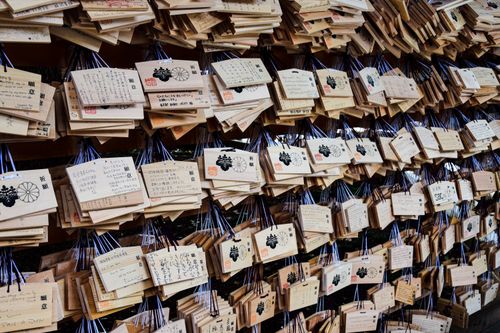 Free Close-up view of wooden ema prayer plaques hanging at a traditional Japanese shrine. Stock Photo
