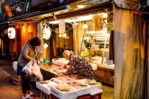 A Woman Buying Groceries on a Street Market