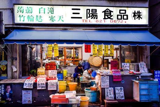 Colorful Asian market stall with non-Western signage, goods, and street vendors.