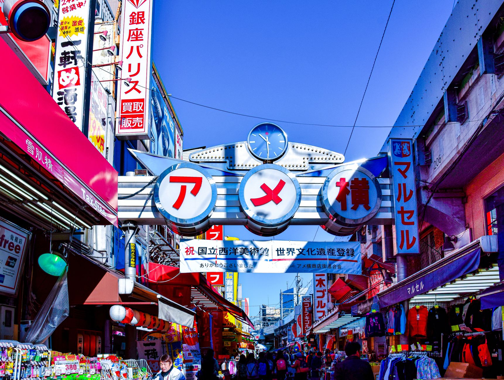 Vibrant street market scene in Japan with colorful signage and busy atmosphere.