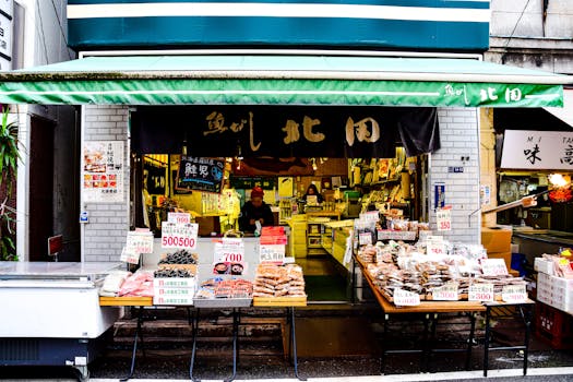 Lively Japanese street market featuring various food stalls with fresh produce.