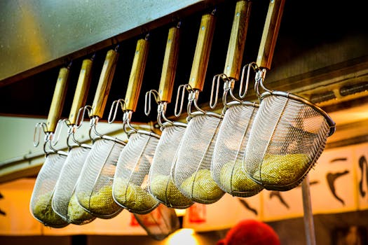 A close-up of noodle strainers hanging in a Japanese ramen restaurant, showcasing culinary tools.
