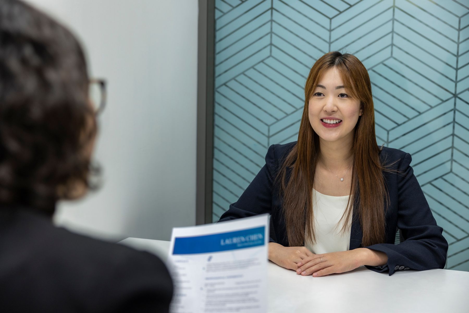 East Asian candidate in a professional interview discussion