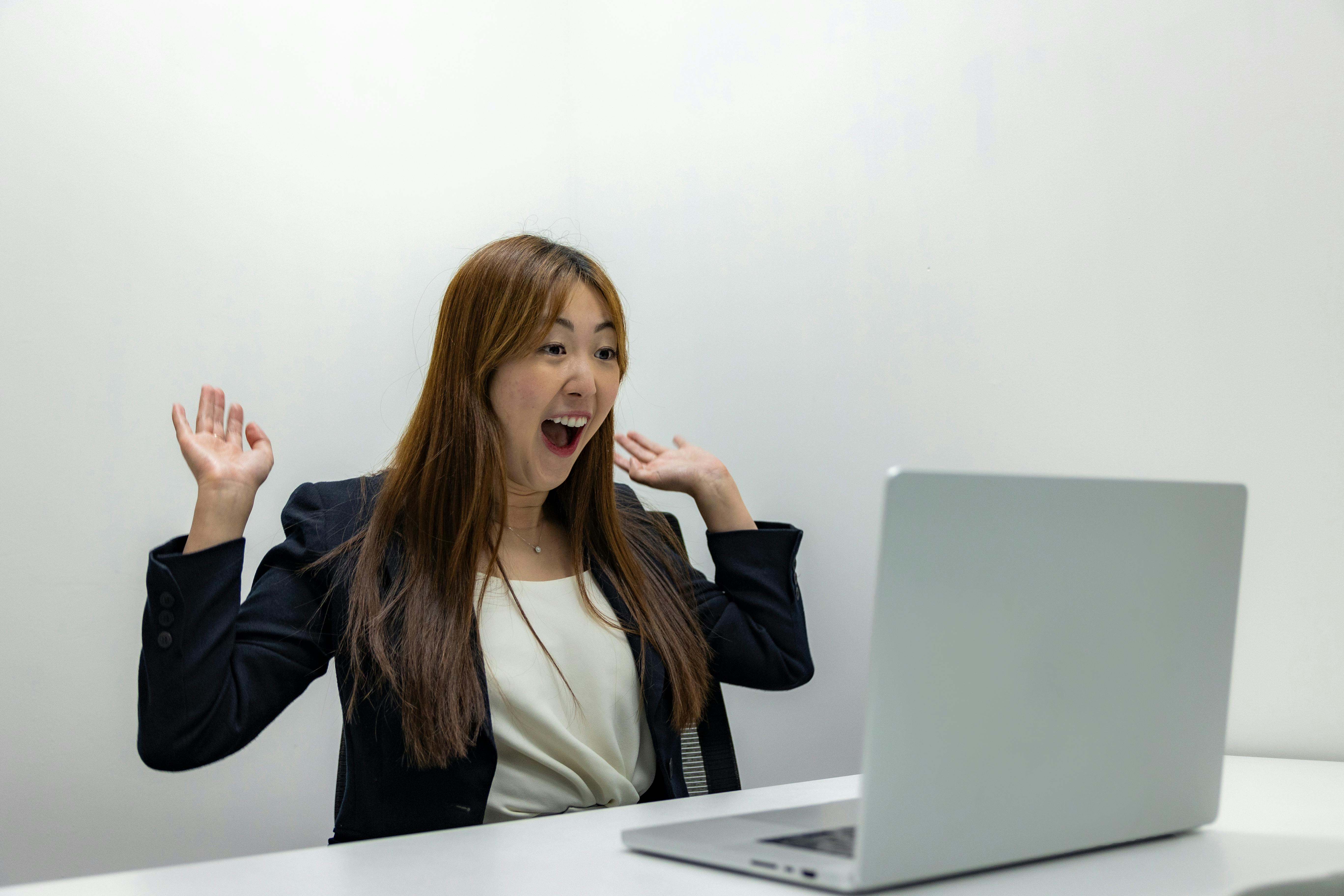 excited businesswoman recording sales video laptop office