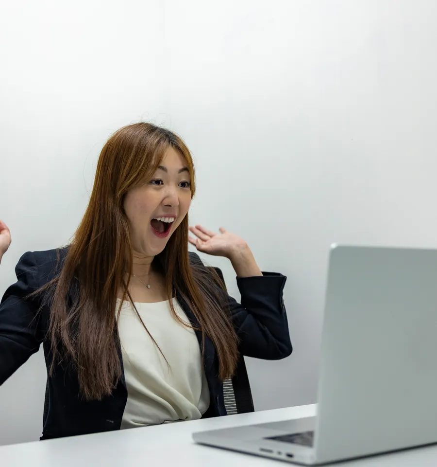 Asian businesswoman excited about new leads on her laptop