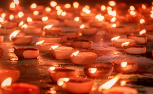 Free A warm display of diya lamps creating a festive atmosphere during Diwali, the Festival of Lights. Stock Photo