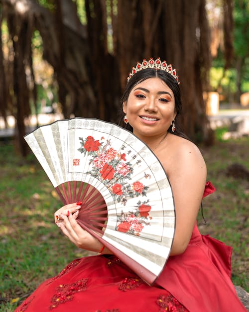Young Woman in a Red Gown and a Traditional Chinese Fan 