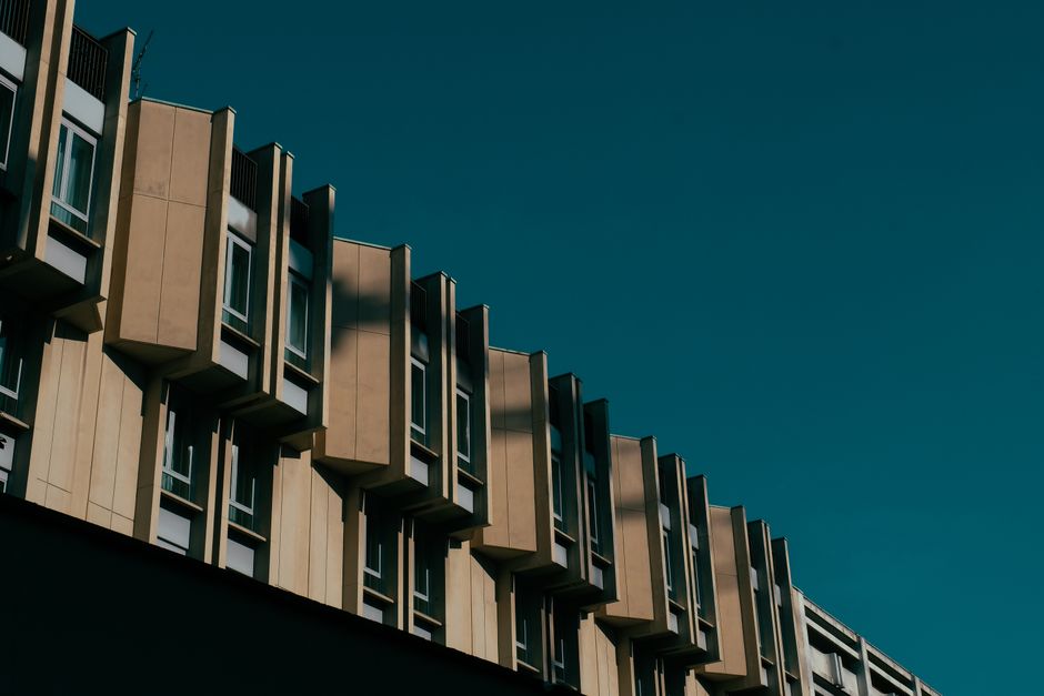 Low angle shot of modern urban building facade with geometric design.