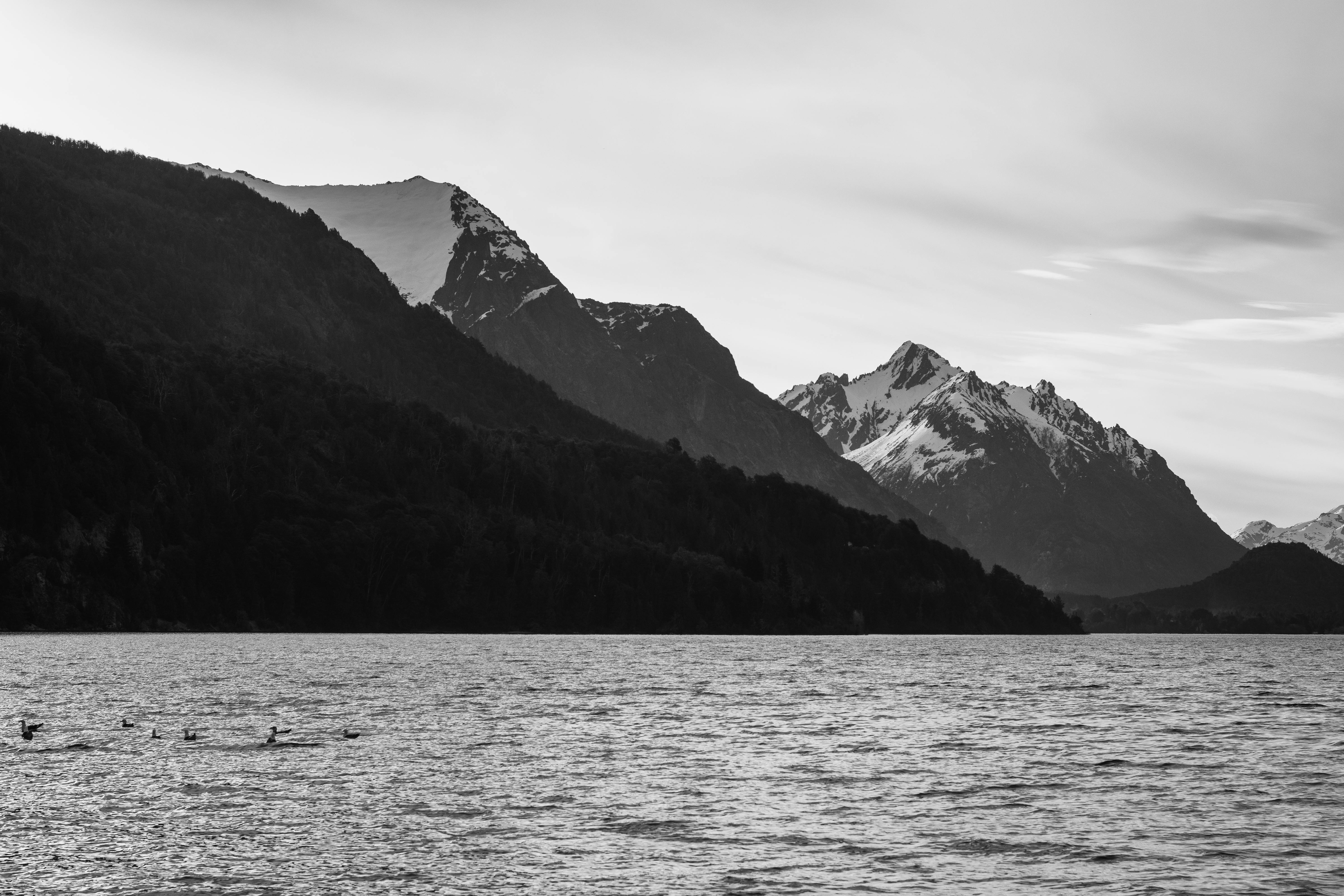 Dramatic black and white mountains over lake in Bariloche, Argentina.