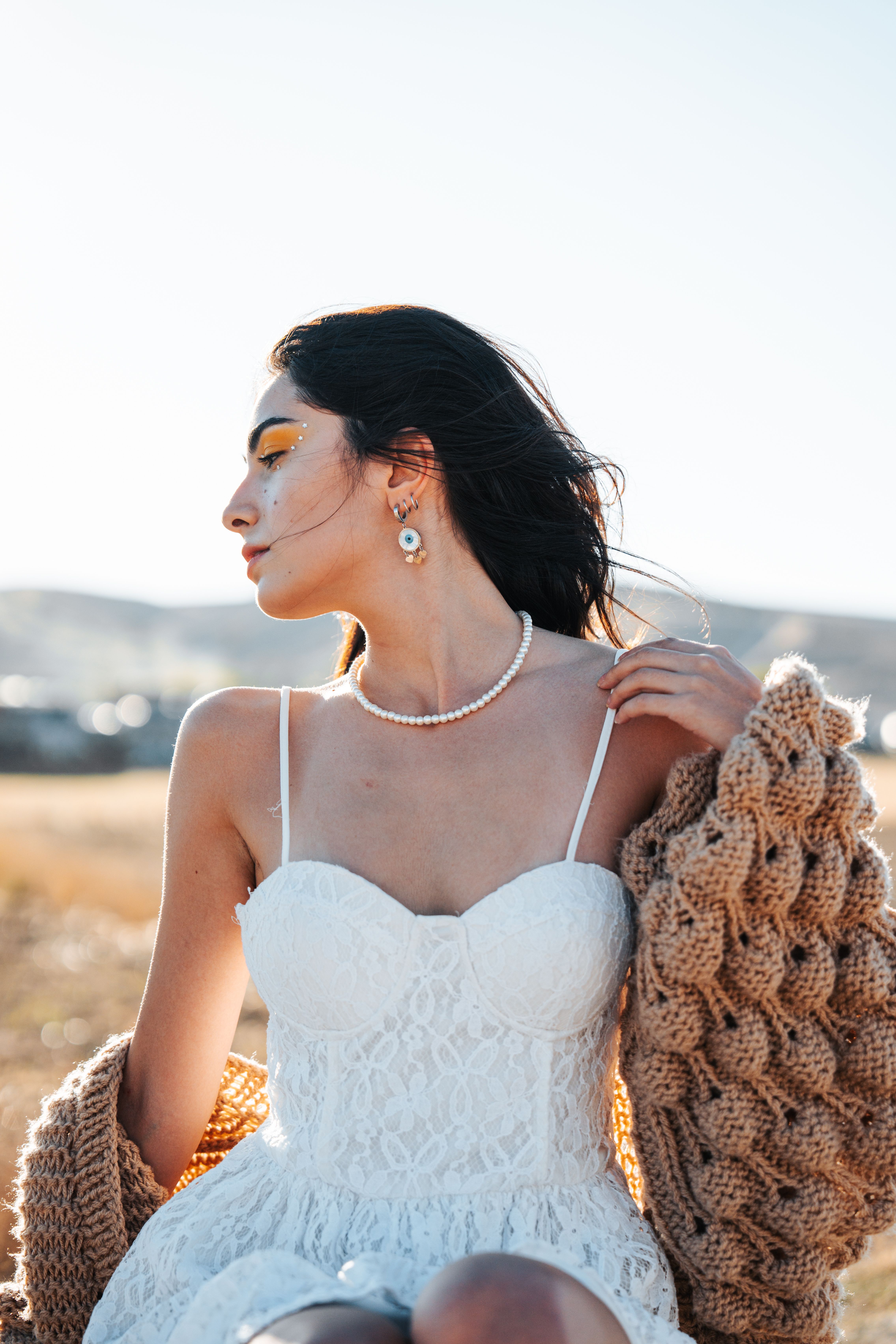 Woman Posing in White Lace Bustier Dress and Beige Knit Cardigan  Free  Stock Photo