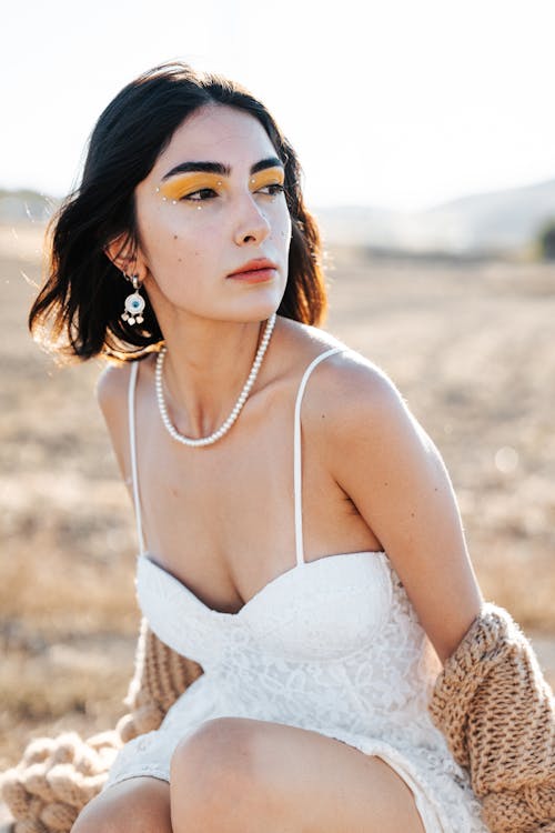 Model in White Dress Wearing Glamour Makeup