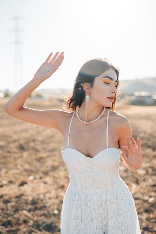 Young Woman in a White Spaghetti Strap Mini Dress and a Pearl Necklace Free Stock Photo Young Woman in a White Spaghetti Strap Mini Dress and a Pearl Necklace Free Stock Photo