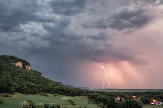 Captivating view of a thunderstorm with lightning over rolling hills in Nelson, Wisconsin.