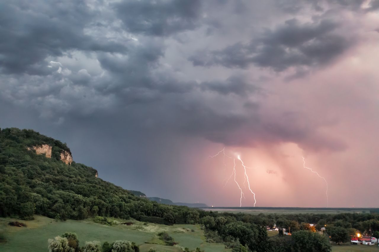 captivating view of a thunderstorm with lightning over rolling hills i