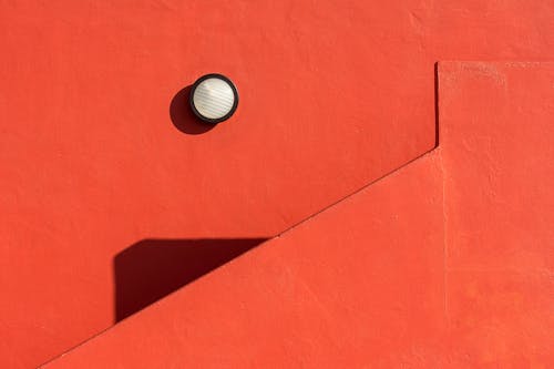 Red Wall with Round Lamp