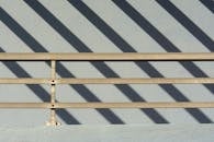 Metal Railing and a Shadow Forming Stripes on the Ground