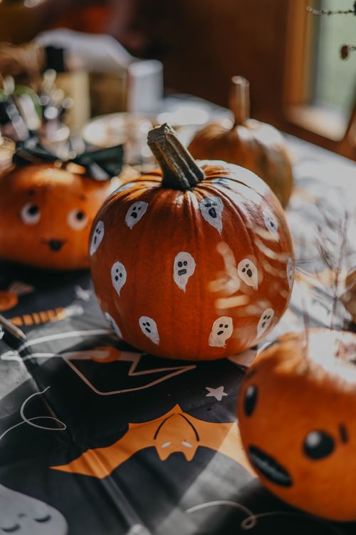 Free Close-up of painted pumpkins with ghost designs for Halloween decoration. Stock Photo