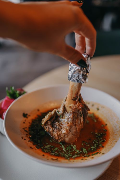 Lamb Hand Hand Holding a Piece of Lamb · Free Stock Photo