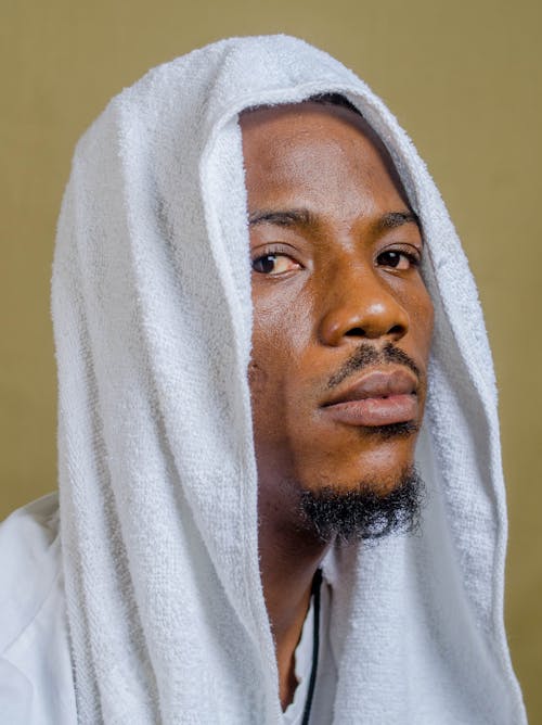 Close-Up Photo of a Young Man in White Hood