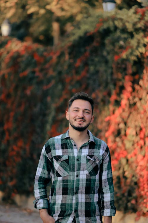 Brunette Man Posing in Checked Shirt in a Park